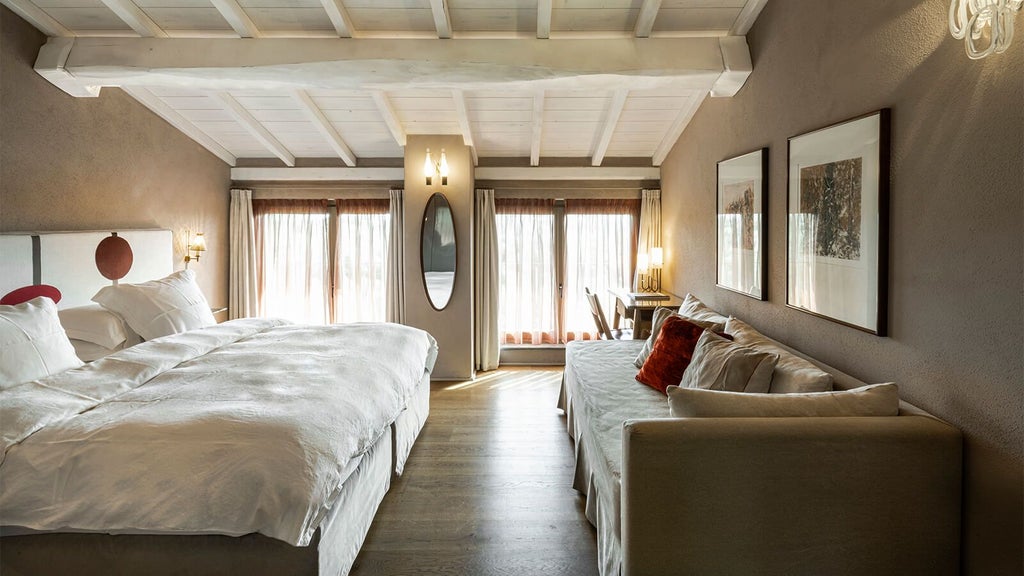 Elegant Tuscan-style boutique hotel room with minimalist decor, soft natural light, white linens, rustic wooden floors, and panoramic countryside view