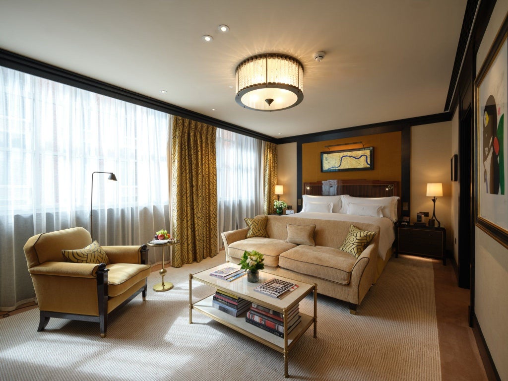 Elegant superior studio at a luxury boutique hotel in Mayfair, featuring plush bedding, refined decor, and sophisticated neutral color palette with contemporary furnishings