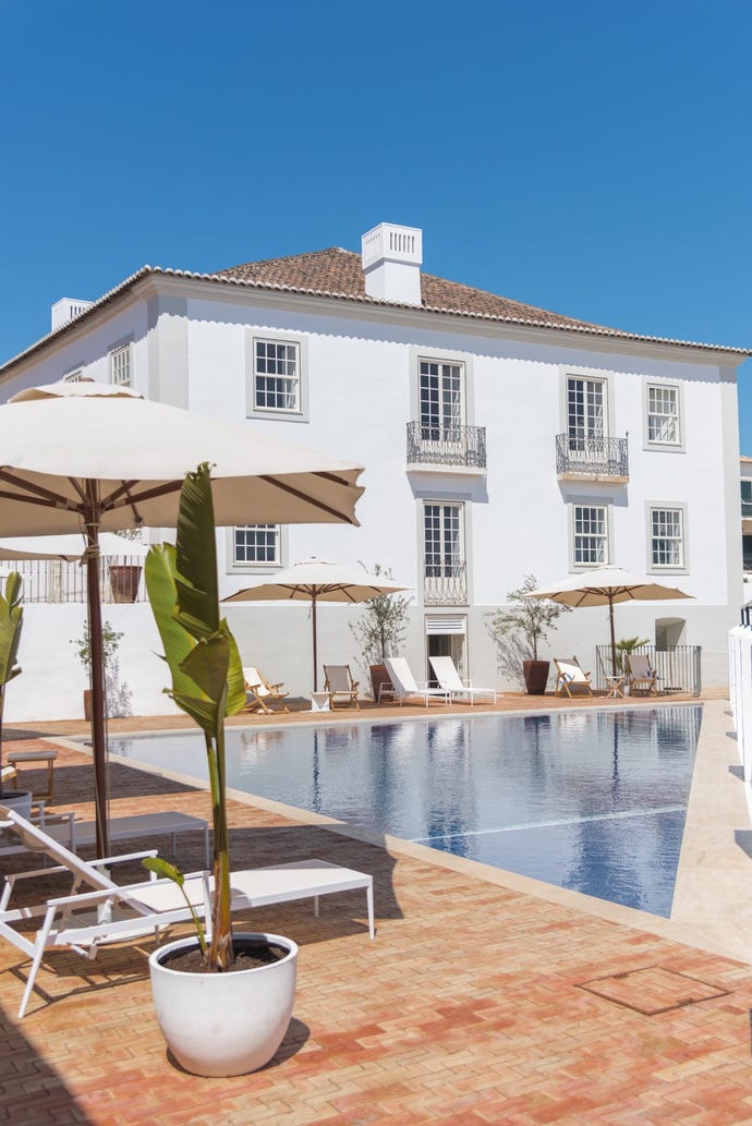 Recline on a lounger by the pool at Casa Mãe