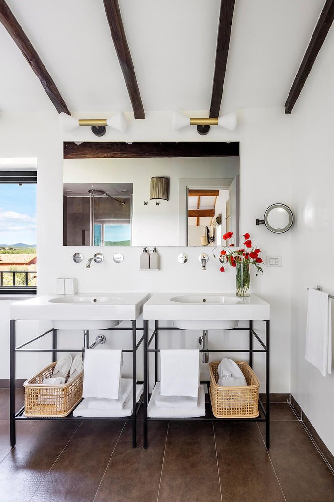 Elegant Italian junior suite with warm terracotta tones, rustic wooden furnishings, plush white bedding, and soft natural light streaming through arched windows