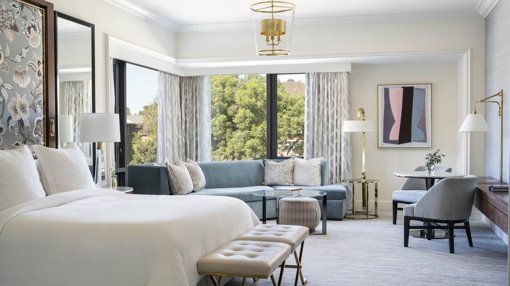 Spacious Four Seasons Deluxe Room with plush king bed, elegant neutral decor, large windows, and modern amenities in tranquil Westlake Village setting