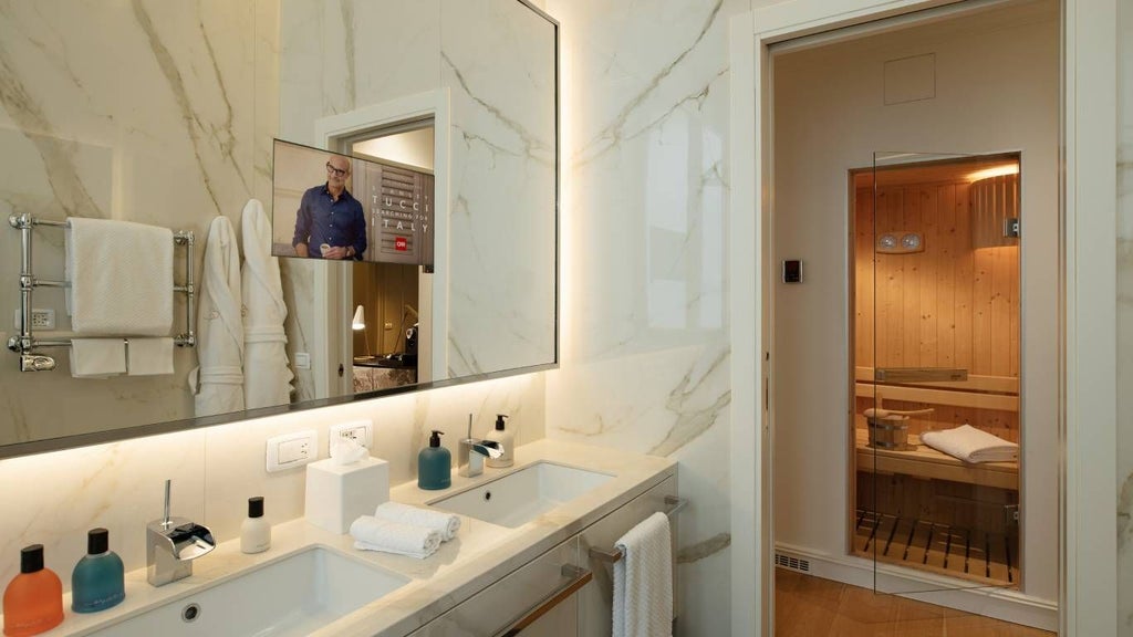 Luxurious corner spa suite with modern Italian design, featuring plush bedding, elegant marble bathroom, and expansive city views in Rome's stylish boutique hotel.