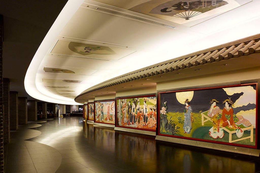 Modern Japanese luxury hotel exterior with sleek glass facade, traditional garden elements, and illuminated entrance at dusk