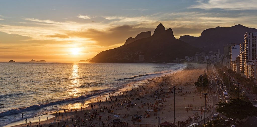 Modern luxury beachfront hotel in Rio with sleek glass facade, overlooking Ipanema Beach, rooftop infinity pool and ocean views