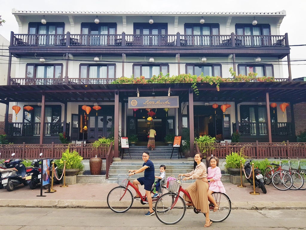 Elegant boutique hotel nestled in Hoi An's historic district, featuring traditional Vietnamese architecture with modern luxury touches and lush tropical surroundings