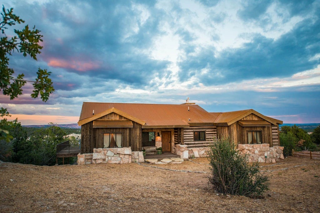 Rustic luxury lodge nestled against red rock cliffs, wooden cabins with scenic mountain views of southwestern landscape near Zion National Park