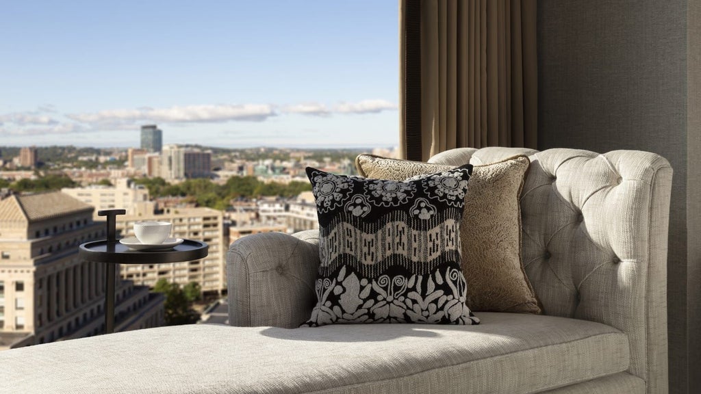 Luxurious superior room at Four Seasons in Boston, featuring elegant contemporary design with plush bedding, city view, and modern amenities in soft neutral tones