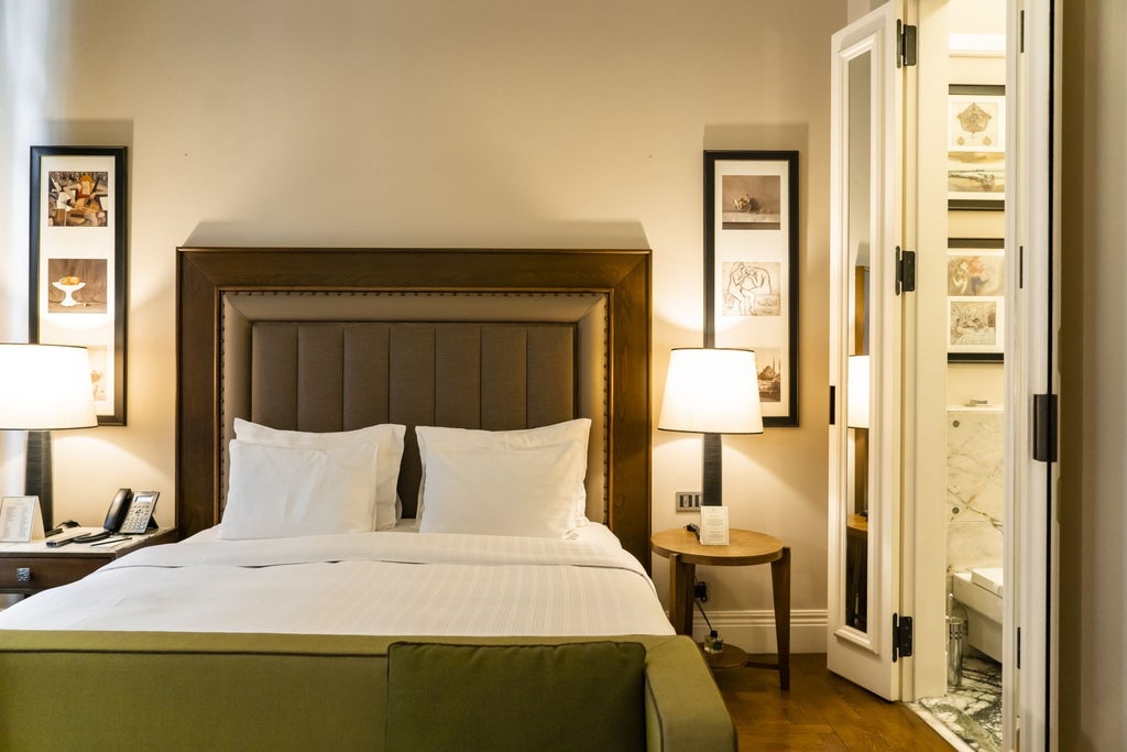 Elegant deluxe king room at scenset hotel in Istanbul, featuring plush bedding, modern Turkish decor, and warm wooden accents with city skyline view