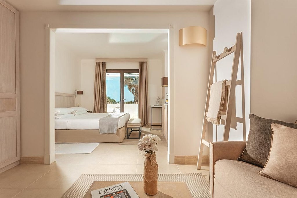 Elegant junior suite with white minimalist decor, large windows overlooking Italian landscape, plush king bed, and contemporary designer furnishings in neutral tones