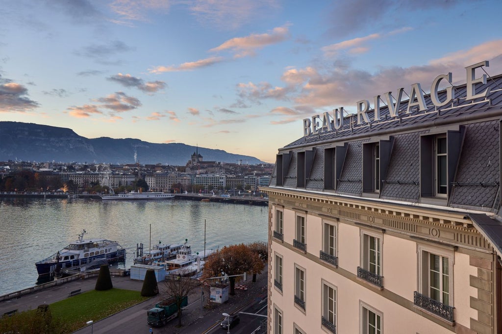 Five-star lakeside hotel with elegant white facade, ornate Belle Époque architecture, and wrought-iron balconies overlooking Lake Geneva