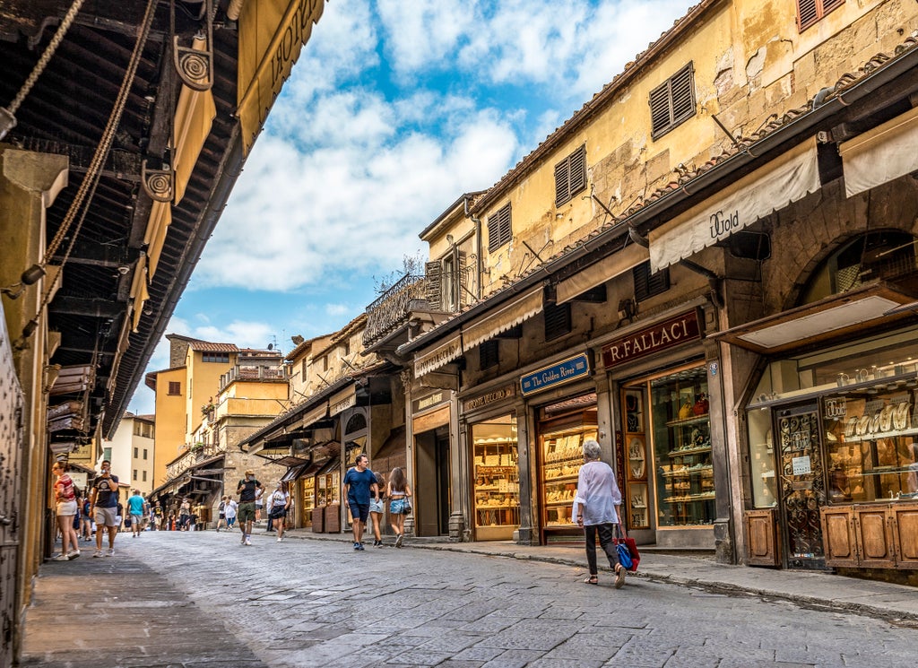 Elegant rooftop terrace in Florence overlooking historic Duomo cathedral, adorned with Renaissance-style furnishings and potted plants