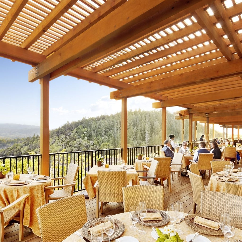 Luxurious Mediterranean-style resort nestled in Napa Valley hillside with infinity pool overlooking sun-drenched vineyard terraces