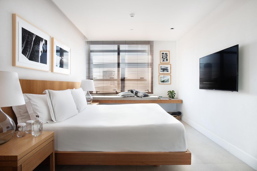 Luxurious Janeiro Hotel deluxe room with panoramic ocean view, sleek modern furnishings, floor-to-ceiling windows, and minimalist Brazilian design aesthetic