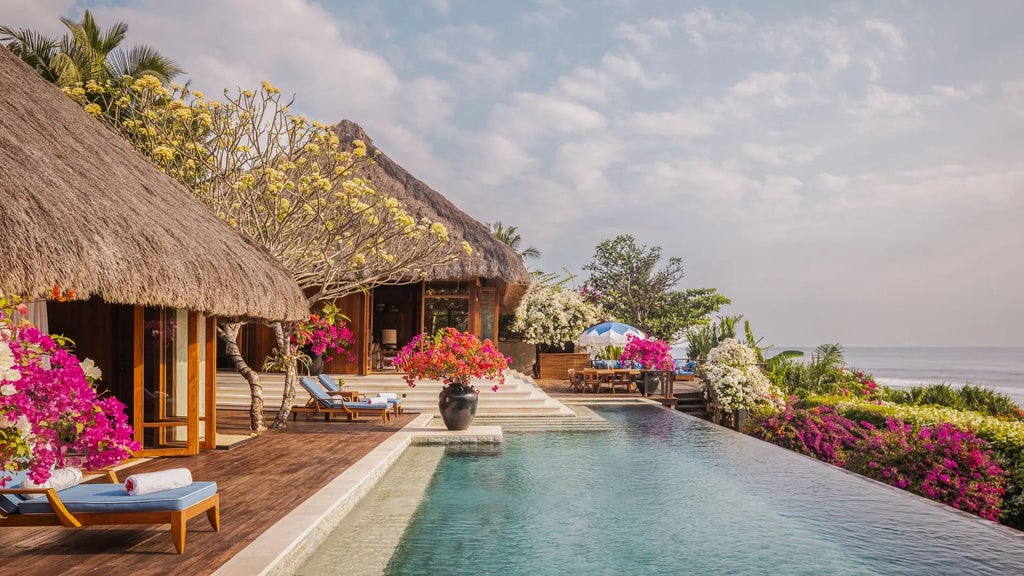 Luxurious eco-resort nestled on a cliff overlooking turquoise waters, with traditional Indonesian architecture and lush tropical vegetation at scenset resort.