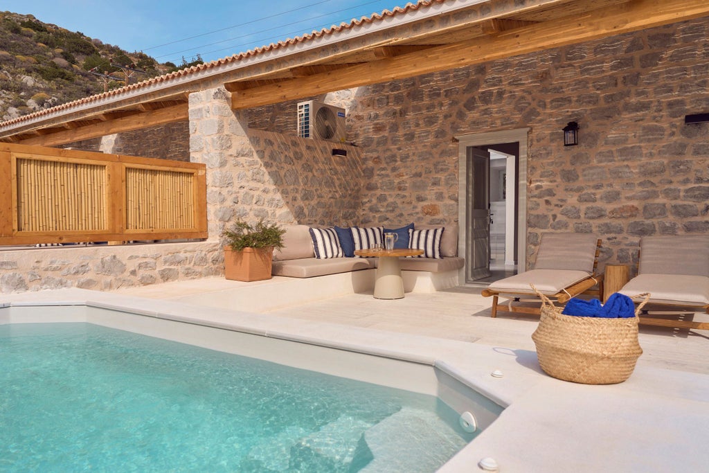 Elegant beachfront suite with private infinity pool overlooking Mediterranean Sea, featuring modern furniture and seamless indoor-outdoor living