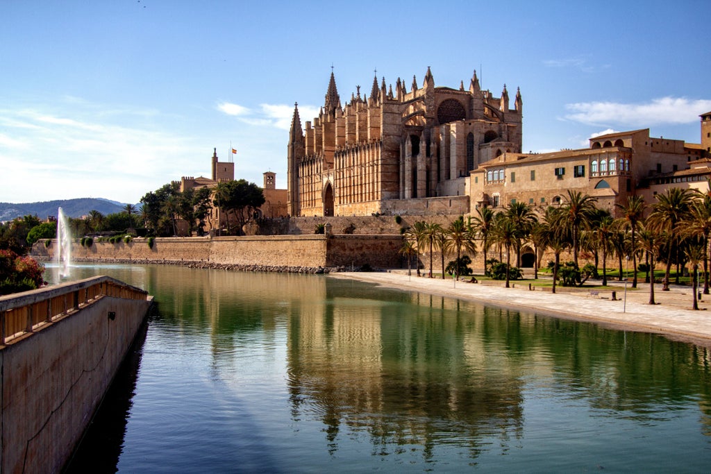 Historic Palma de Mallorca stone street with elegant architecture, vibrant Mediterranean sunlight, and charming traditional Spanish balconies