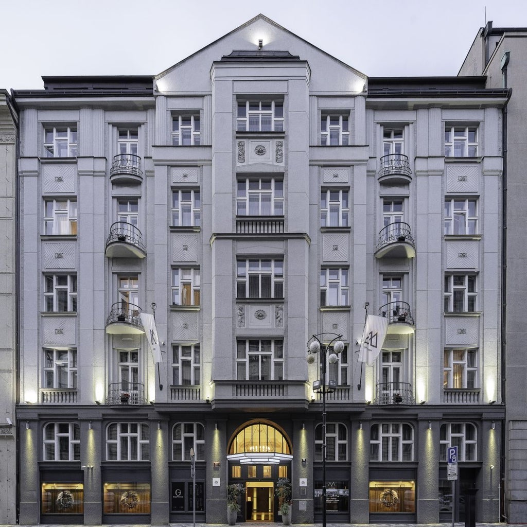 Luxurious interior of a high-end hotel lobby in Prague, featuring elegant contemporary design with plush seating and sophisticated lighting accents