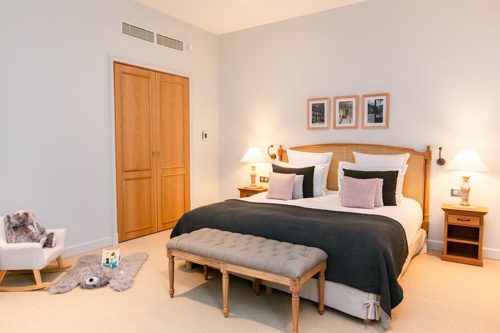 Elegant Premier room in Hôtel Chais Monnet & Spa with soft neutral tones, plush bedding, and sophisticated French design overlooking historic Cognac landscape