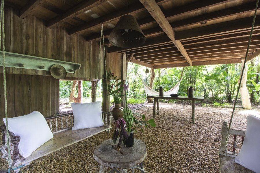 Luxurious treehouse suite at UXUA Casa Hotel and Spa, suspended amid lush Brazilian greenery with rustic wooden interiors and elegant tropical design elements