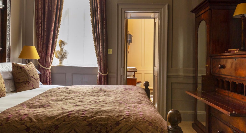 Elegant club double room at Hazlitt's, featuring rich dark wood furnishings, plush bedding, and refined British sophistication with vintage-inspired decor