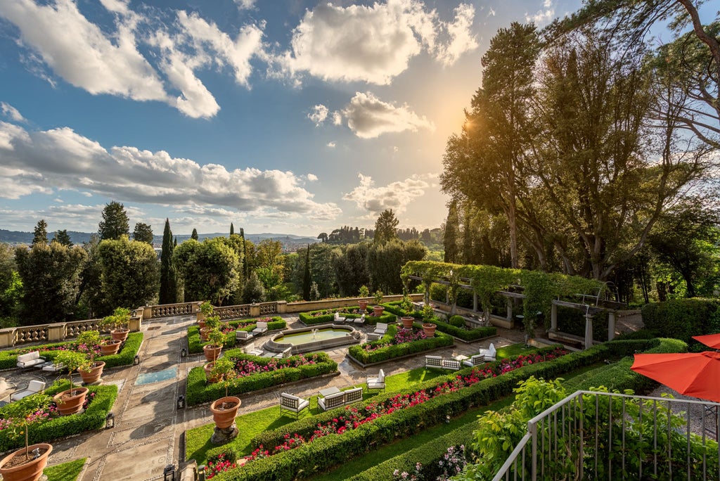 Italian Renaissance villa turned luxury hotel nestled in Tuscan hillside, with manicured gardens and sweeping Florence views