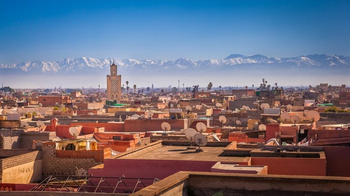 Marrakech stands at the foot of the High Atlas mountain range