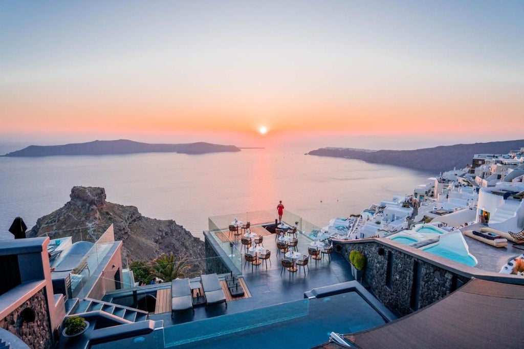 Elegant white-washed Cycladic suites with private pools overlooking Oia's caldera, showcasing luxurious minimalist design and breathtaking Santorini sunset views