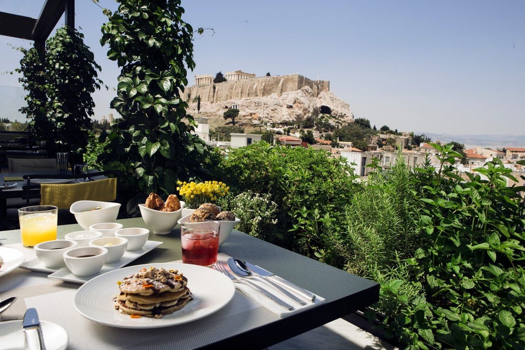 Modern luxury hotel exterior in Athens with clean geometric lines, glass facade, and minimalist balconies overlooking the historic city