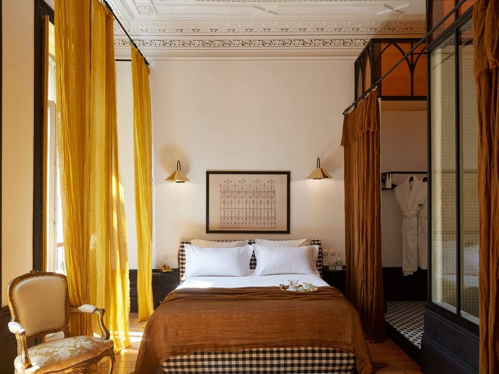 Elegant Superior room at Cocorico hotel in Portugal, featuring plush white bedding, minimalist design, and soft natural lighting from large windows