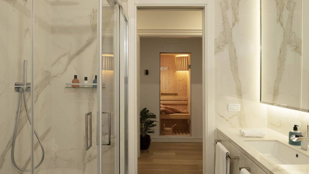 Elegant spa suite with modern Italian design, featuring plush white bed, marble bathroom, and soft mood lighting in a luxurious urban Rome hotel room