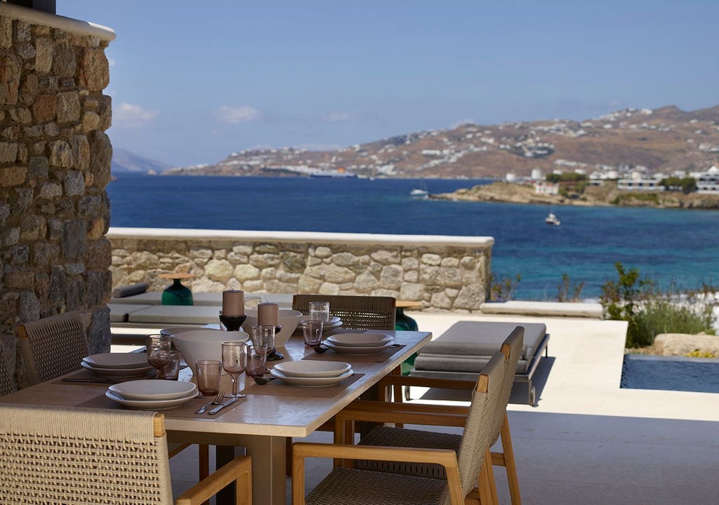 Luxurious three-bedroom villa in Mykonos with panoramic Aegean Sea view, private heated pool, and elegant Mediterranean architectural design