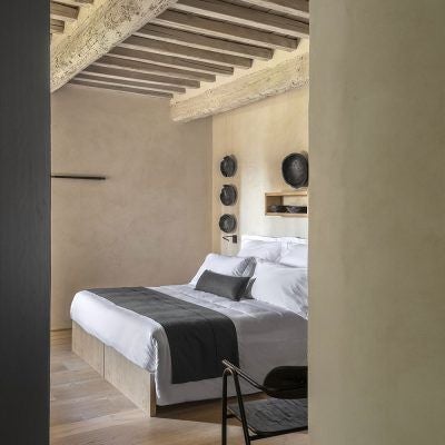 Elegant Italian superior hotel room with panoramic view, rustic wooden furnishings, soft natural light, and scenic landscape of Tuscany countryside