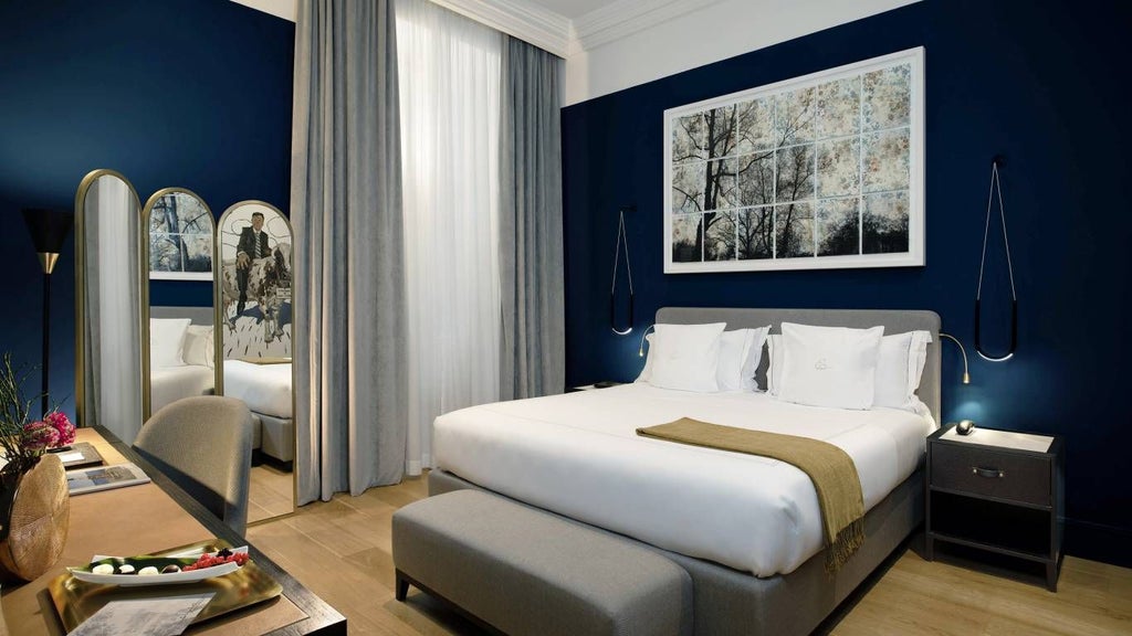 Elegant boutique hotel room with modern Italian design, plush white bedding, marble accents, and soft ambient lighting in Rome's historic center