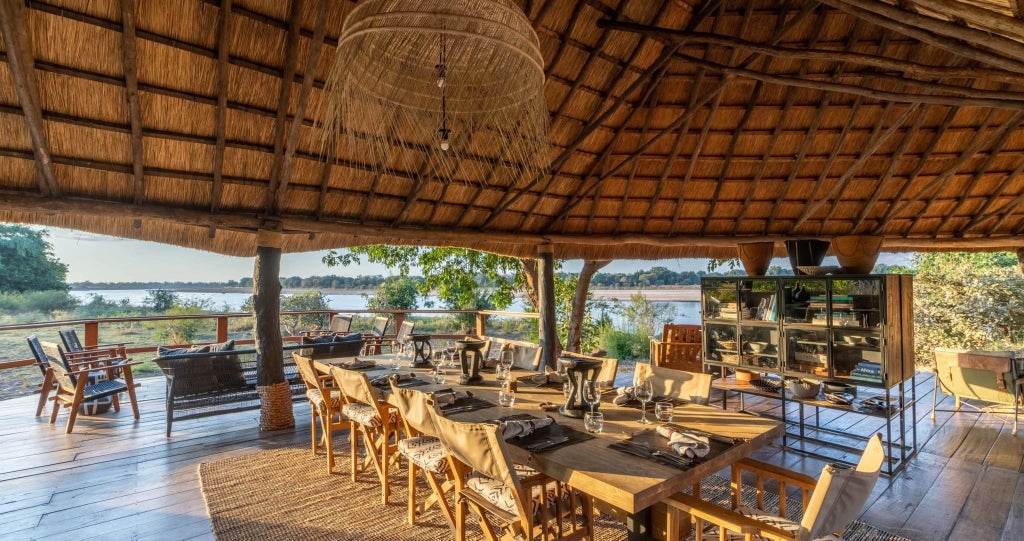Luxurious tented safari camp nestled along the riverbank in South Luangwa National Park, with canvas accommodations blending seamlessly into wild Zambian landscape