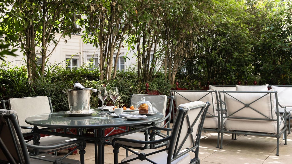 Elegant junior suite terrace at La Réserve Paris Hotel & Spa, featuring chic contemporary design with plush furnishings and Parisian skyline views