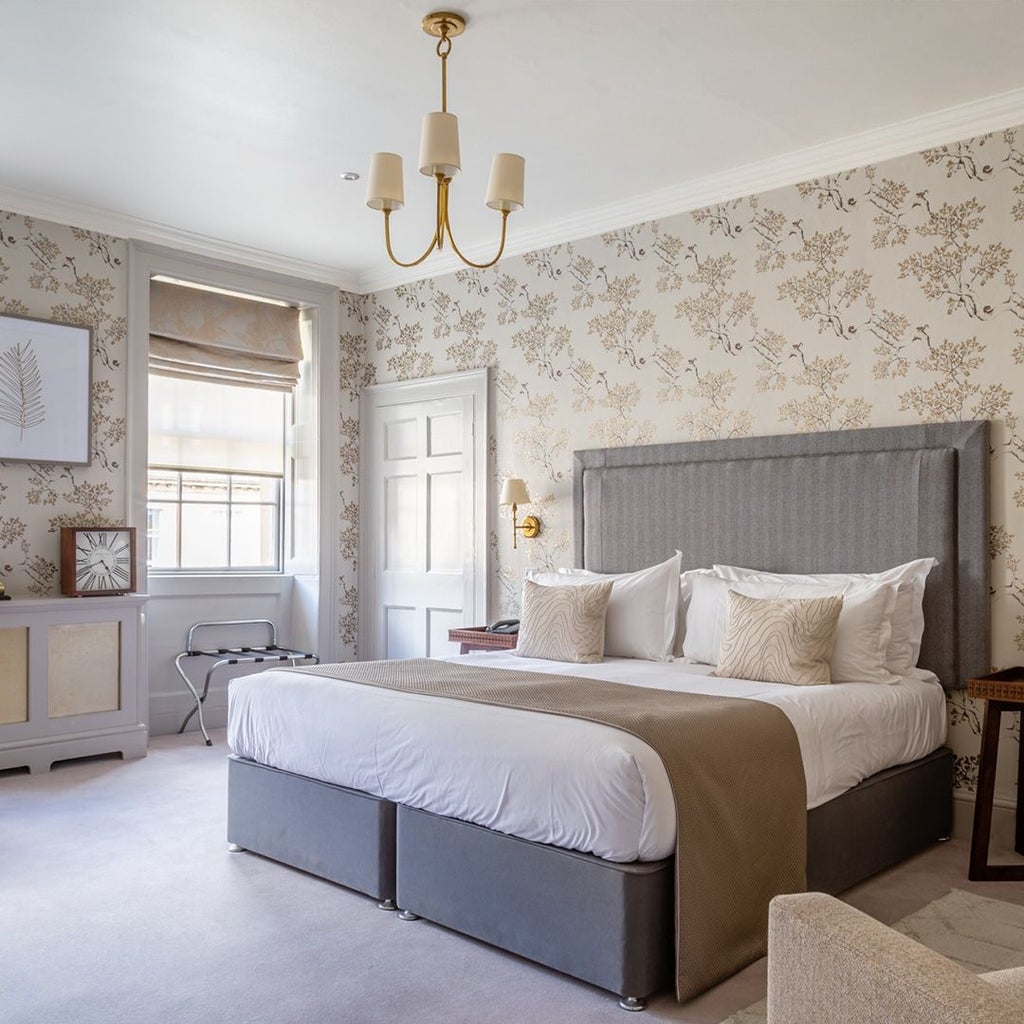 Elegant Georgian townhouse hotel with cream-colored facade, large sash windows, and classic architectural details in Bath, United Kingdom.