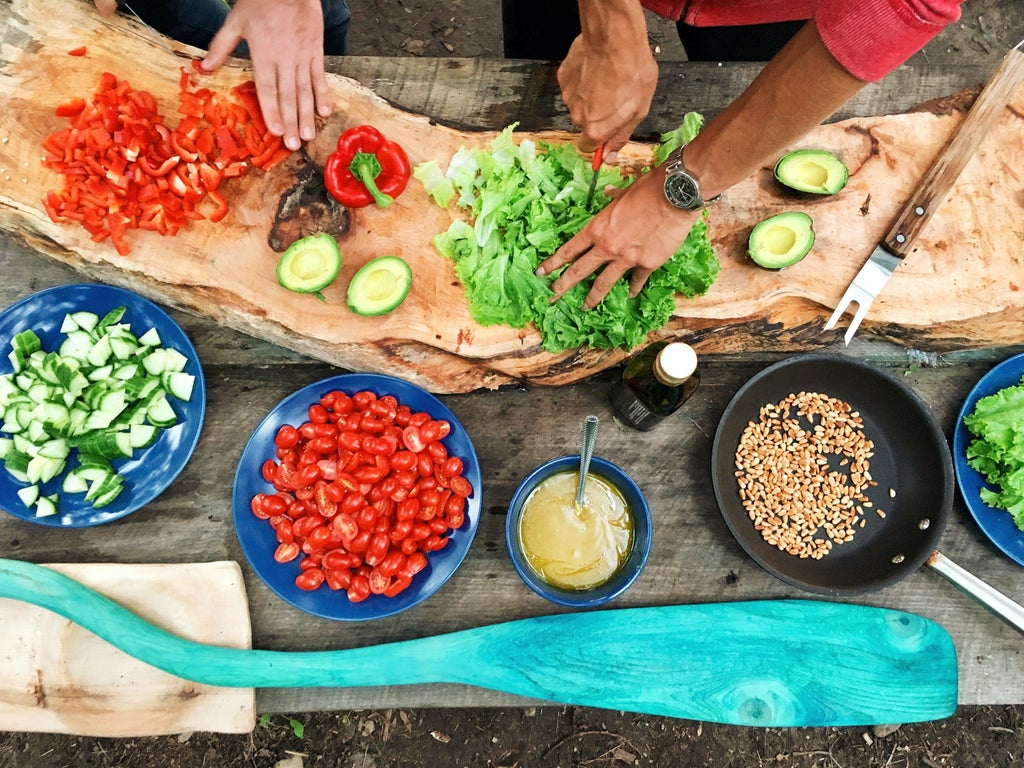 Rooftop terrace overlooking Rovinj's old town with fresh ingredients laid out for luxury seaside cooking class and wine tasting