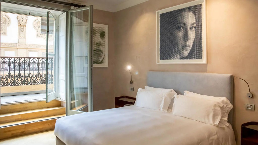 Luxurious hotel room with elegant Italian design, high ceilings, contemporary artwork, and opulent furnishings in Milan's prestigious Galleria Vik Milano