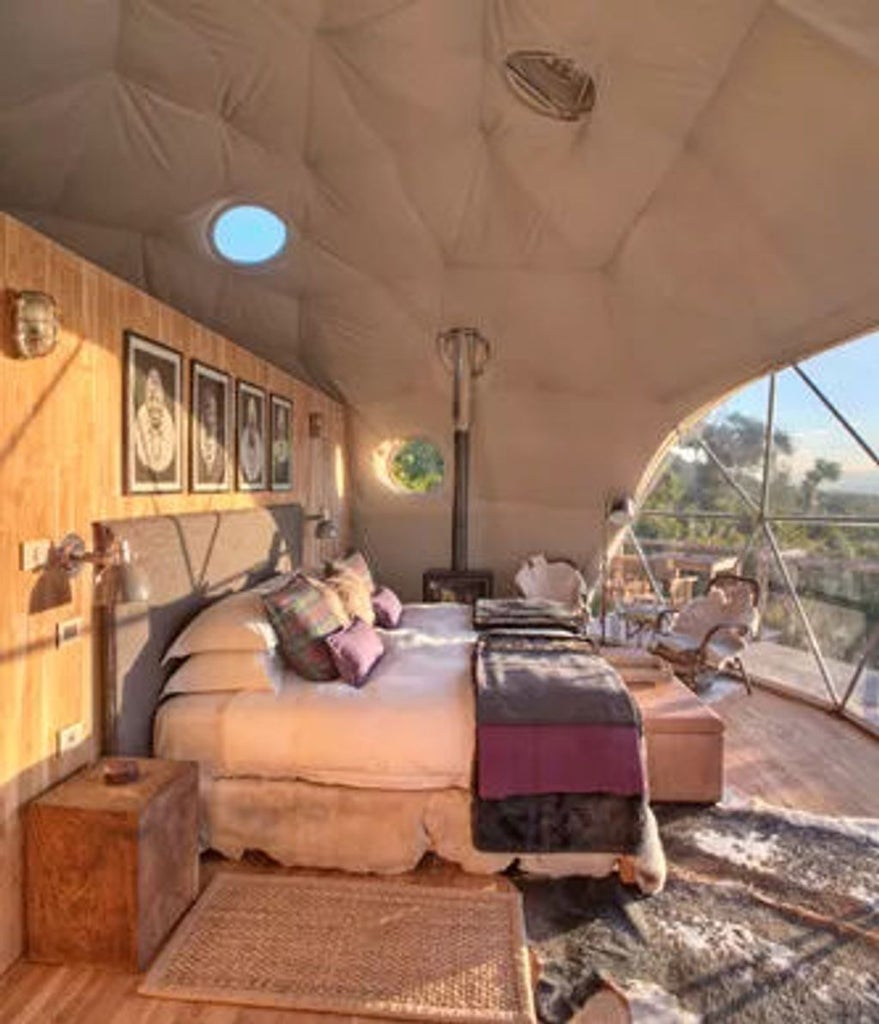 Luxurious safari tent overlooking Ngorongoro Crater, featuring a private deck, canvas canopy and panoramic views of African savanna