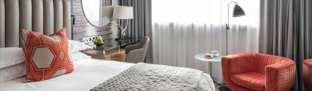 Luxurious deluxe hotel room with plush queen bed, elegant modern decor, soft neutral tones, and sophisticated urban design in scenset hotel, United Kingdom