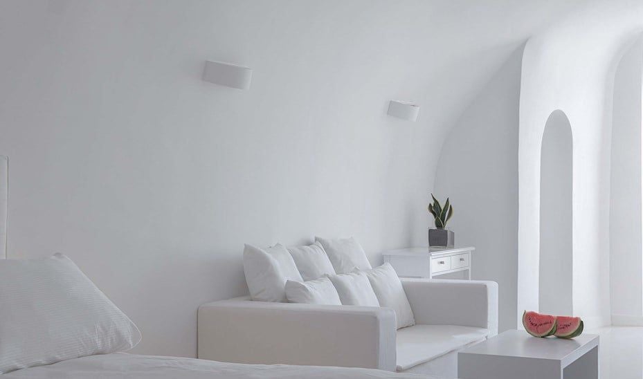 Pristine white-walled Senior Suite with panoramic Aegean Sea view, minimalist elegant design, private balcony, and iconic Santorini architectural style