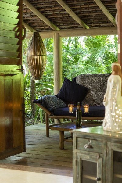 Rustic-chic wooden interior of UXUA Casa Hotel Studio in Trancoso, Brazil, featuring minimalist design with warm earth tones and tropical ambiance