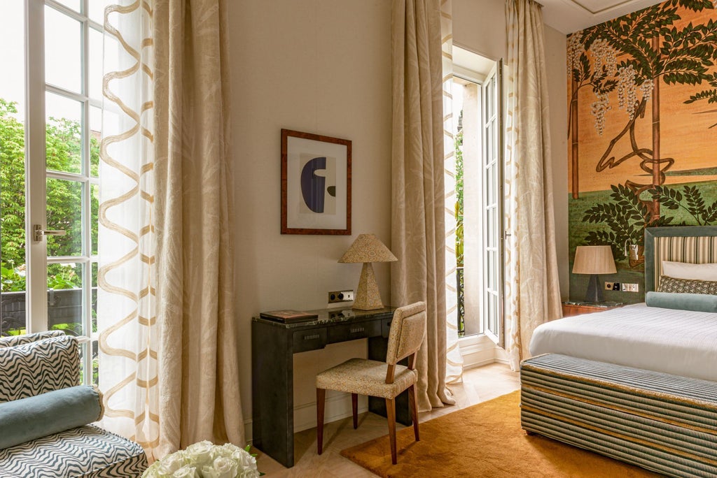 Grand, chateau-style luxury hotel with ornate Second Empire architecture, red-striped awnings, and manicured hedges in an elegant Paris setting