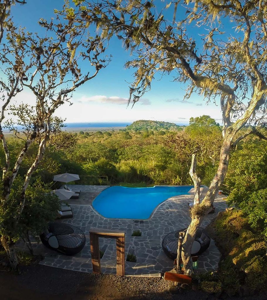 Luxurious safari tent with canvas walls, wooden deck, and panoramic views of Galapagos landscape, blending rustic elegance with modern comfort.