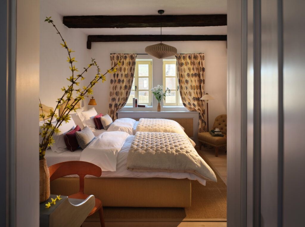 Rustic stone and timber corner barn at Bethlen Estates, showcasing traditional Transylvanian architecture with elegant wooden beams and soft natural light.