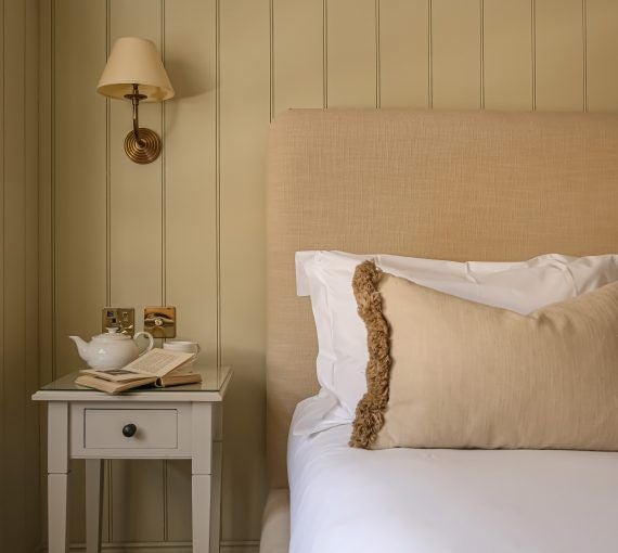 Luxurious deluxe king room with elegant decor, plush bedding, and modern amenities at The Yard hotel in Bath, featuring soft neutral tones and sophisticated design