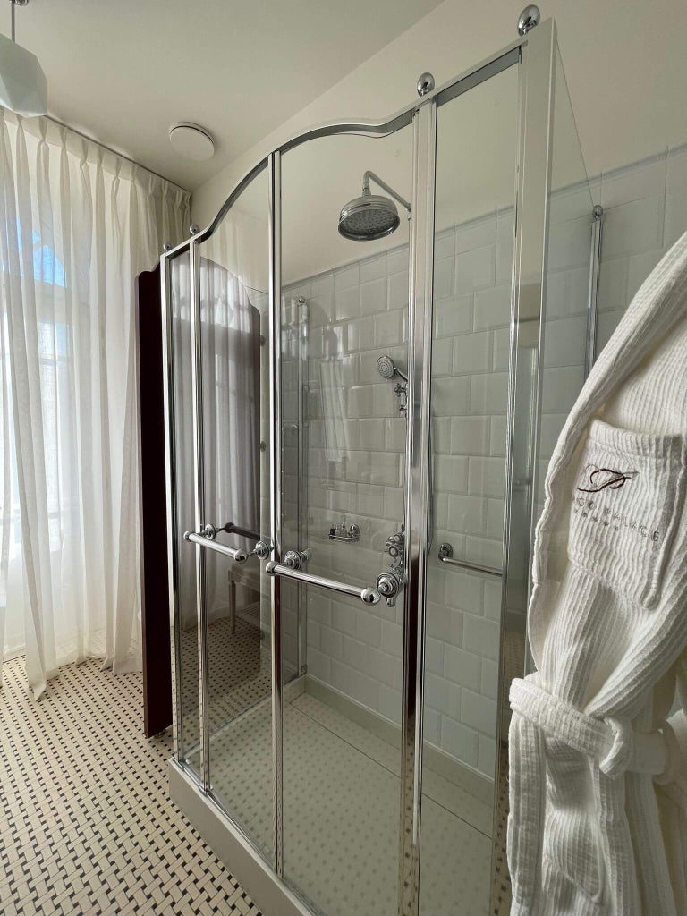 Elegant marble bathroom with ornate gold fixtures, plush white towels, and classic Portuguese design in luxurious Vidago Palace Hotel suite