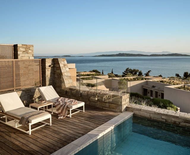 Luxurious one-bedroom pool villa overlooking the Aegean Sea, with modern minimalist design, private infinity pool, and panoramic ocean views in Greece.