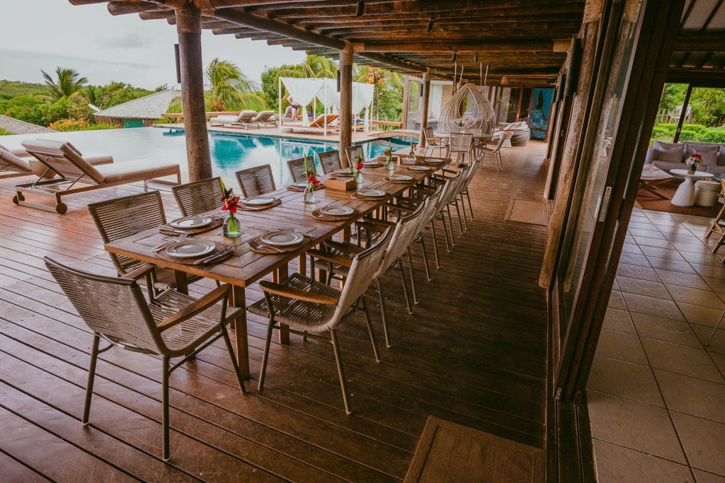 Luxurious Brazilian beachfront boutique hotel with panoramic views of turquoise waters, white sandy coastline, and modern minimalist architecture