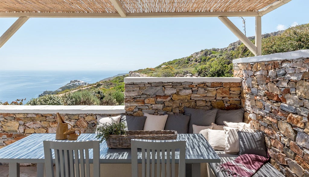 Elegant white-washed Cycladic hotel room with minimalist design, panoramic sea view, blue infinity pool, and soft sunlight in Sifnos, Greece